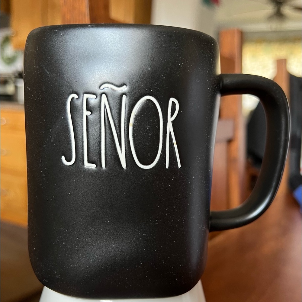 RAE DUNN coffee cup in black with white letters.